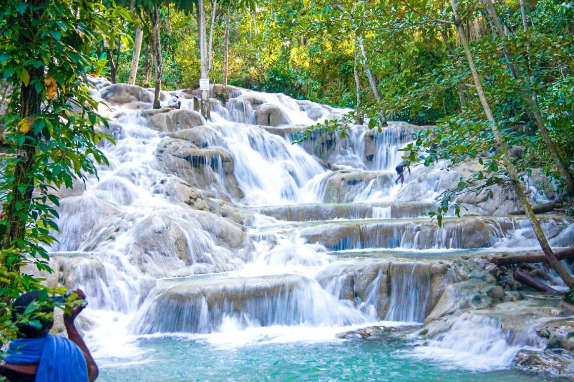 Exploring the Majestic Dunns River Falls in Jamaica. The best tours and excursions in Jamaica. Book the best waterfall, boating, cultural, Horse Riding, Swimming & Bamboo Rafting, Fishing, Dunns Party Catamaran, Climb & Zipline, Waterfalls and Horseback Riding tours across Jamaica with www.jamescarvertours.com